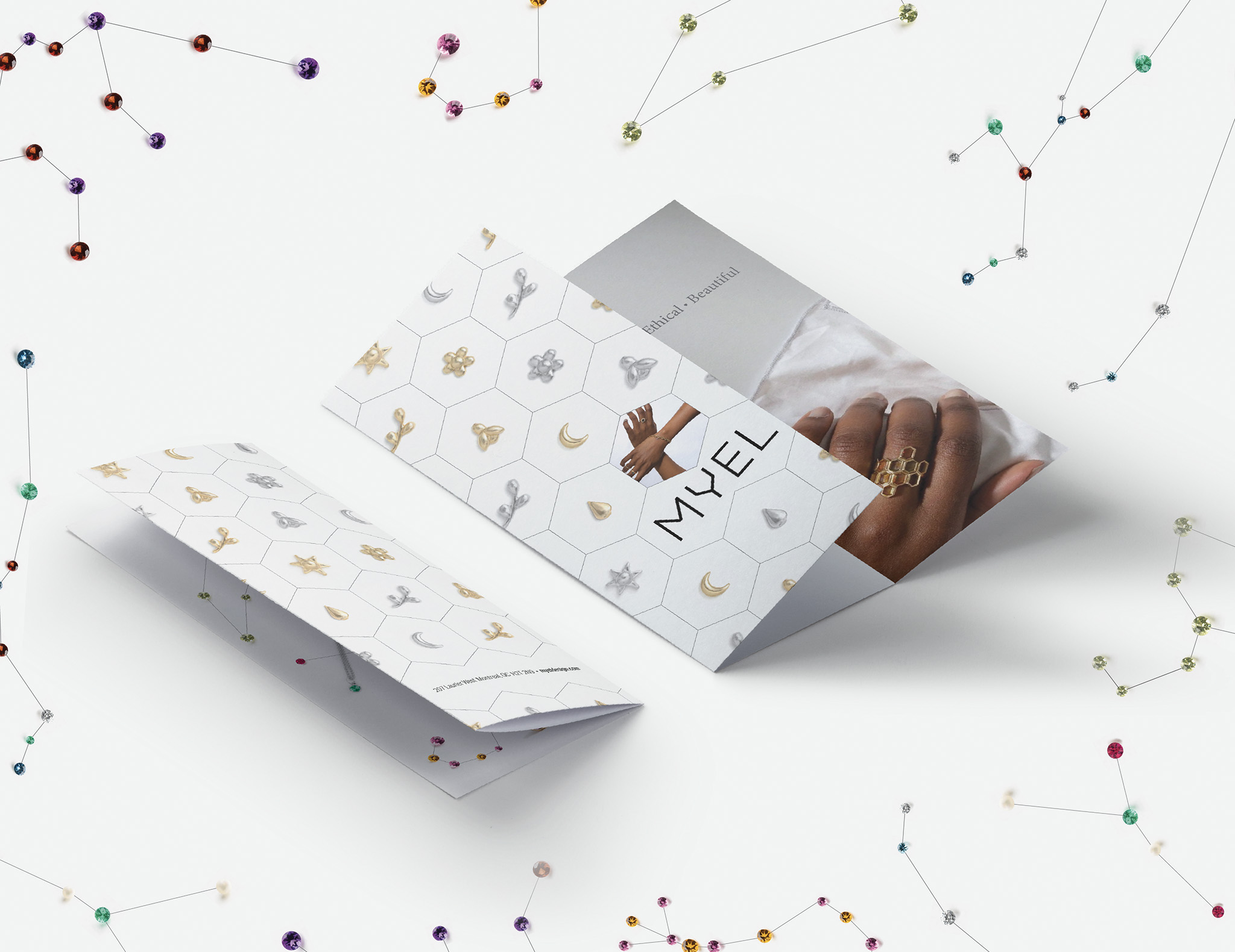 Mockup of promotional brochure for jewellery company Myel laid out with matching background.