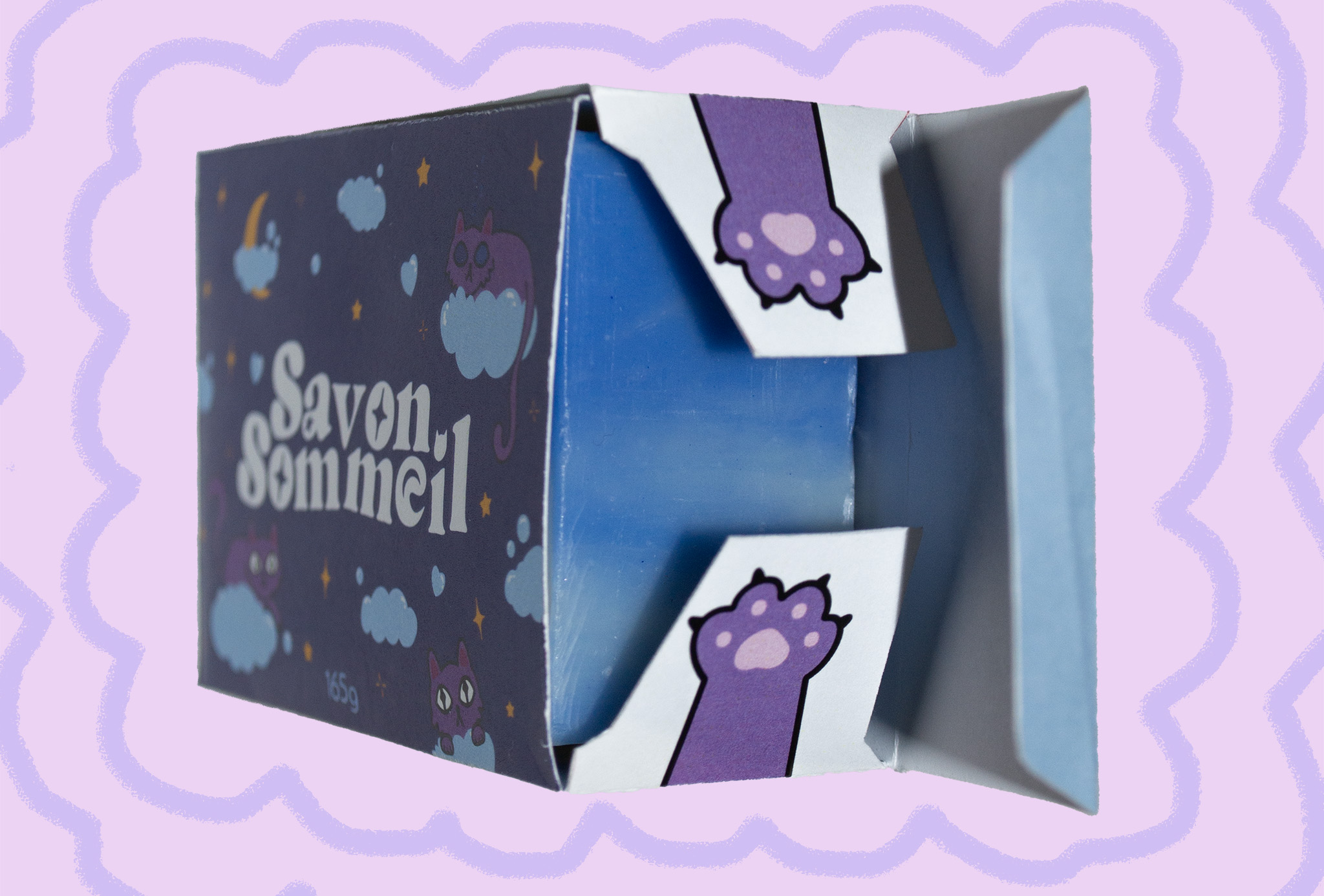 Packaging image of Savon Sommeil packaging displaying paw designs on inner flaps on a cloud style background.